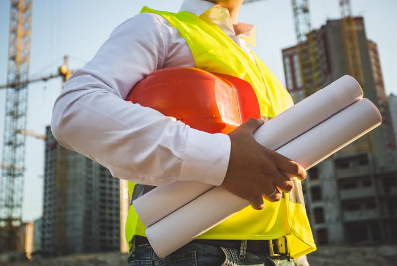 man in shirt and jacket holding hardhat and bluepr 2026 01 07 05 55 35 utc - Rema Construction